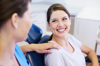 Positive interaction between dental professional and patient in clinical setting, highlighting compassionate care.